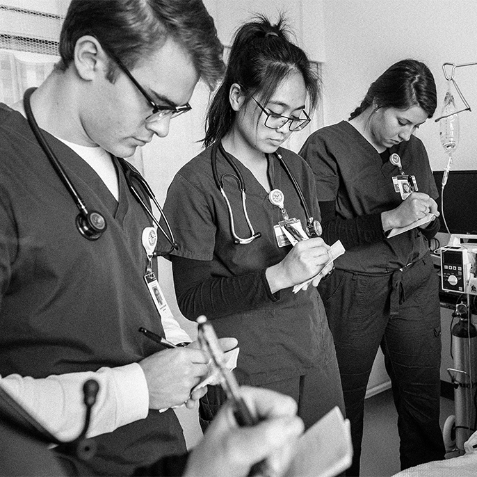 three nursing students taking notes
