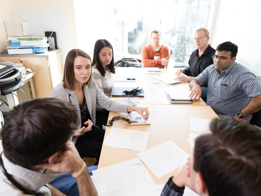 Students sit around a discussion table during a seminar course