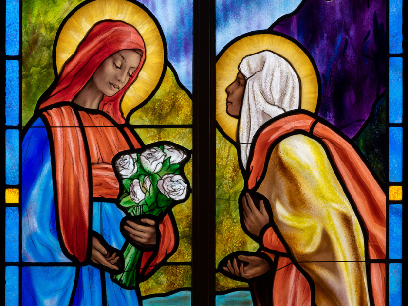 A stained glass window depicting Mary and Martha