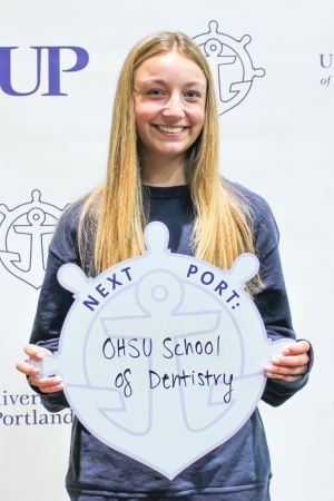 Andie Jamison posing with Next Port sign.