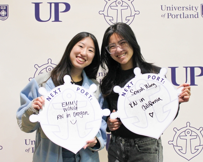 Emmy Wong and Sarah Wong posing with Next Port sign.