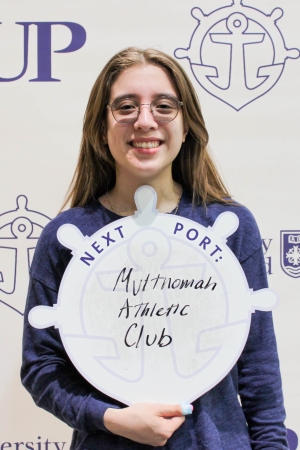 Siena Wheeler posing with Next Port sign.