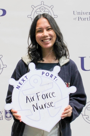 Ysabella Reyes posing with Next Port sign.