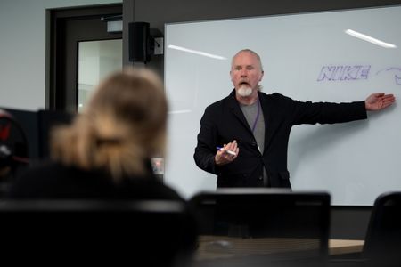 Professor writing on board