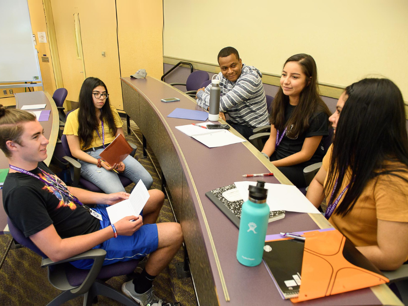 A professor teaching in a classroom with students