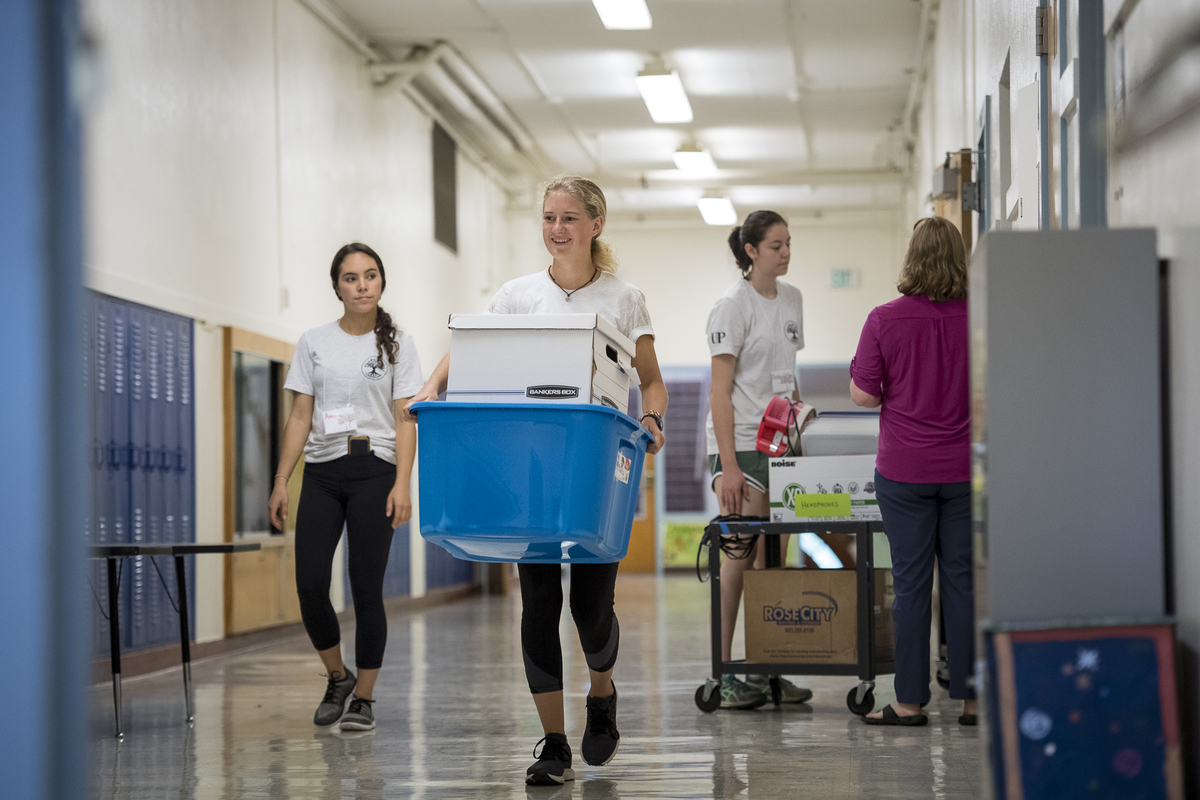 a student holding a box in a school