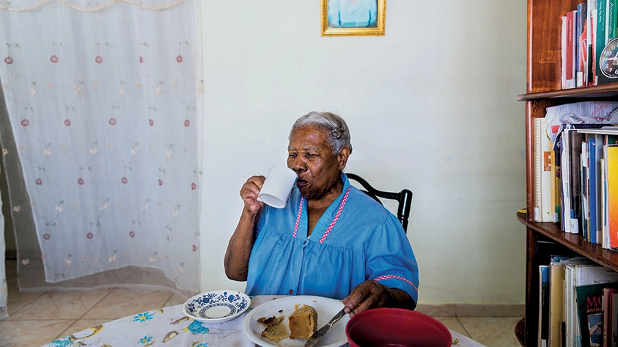 Martha Wilmore sitting at her dining room table