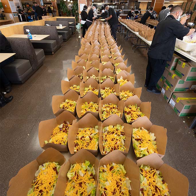 A long line of to-go salads.