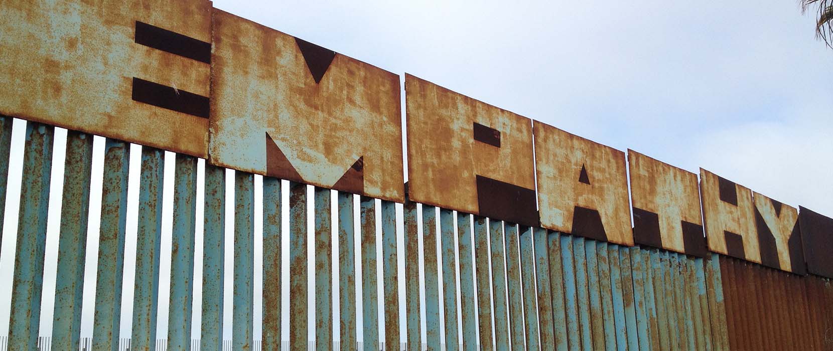 Border wall with the word empathy upon it.