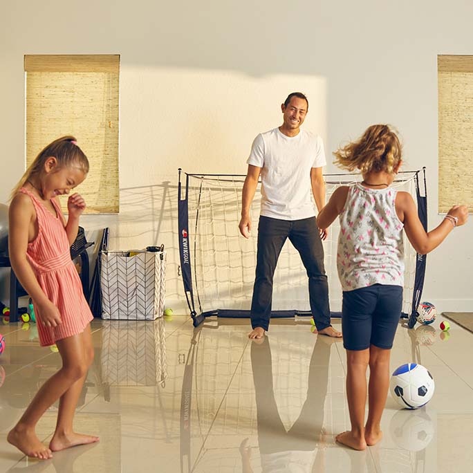 Luis Rubles playing soccer with his children.