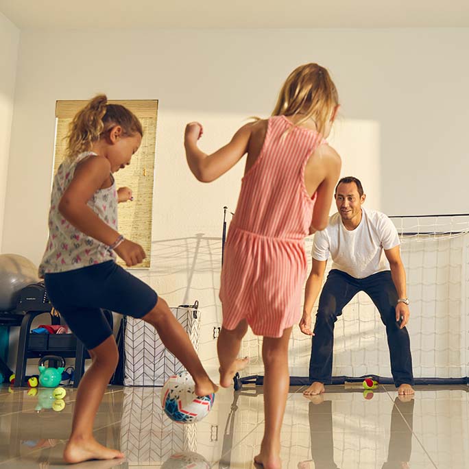 Luis Rubles playing soccer with his children.