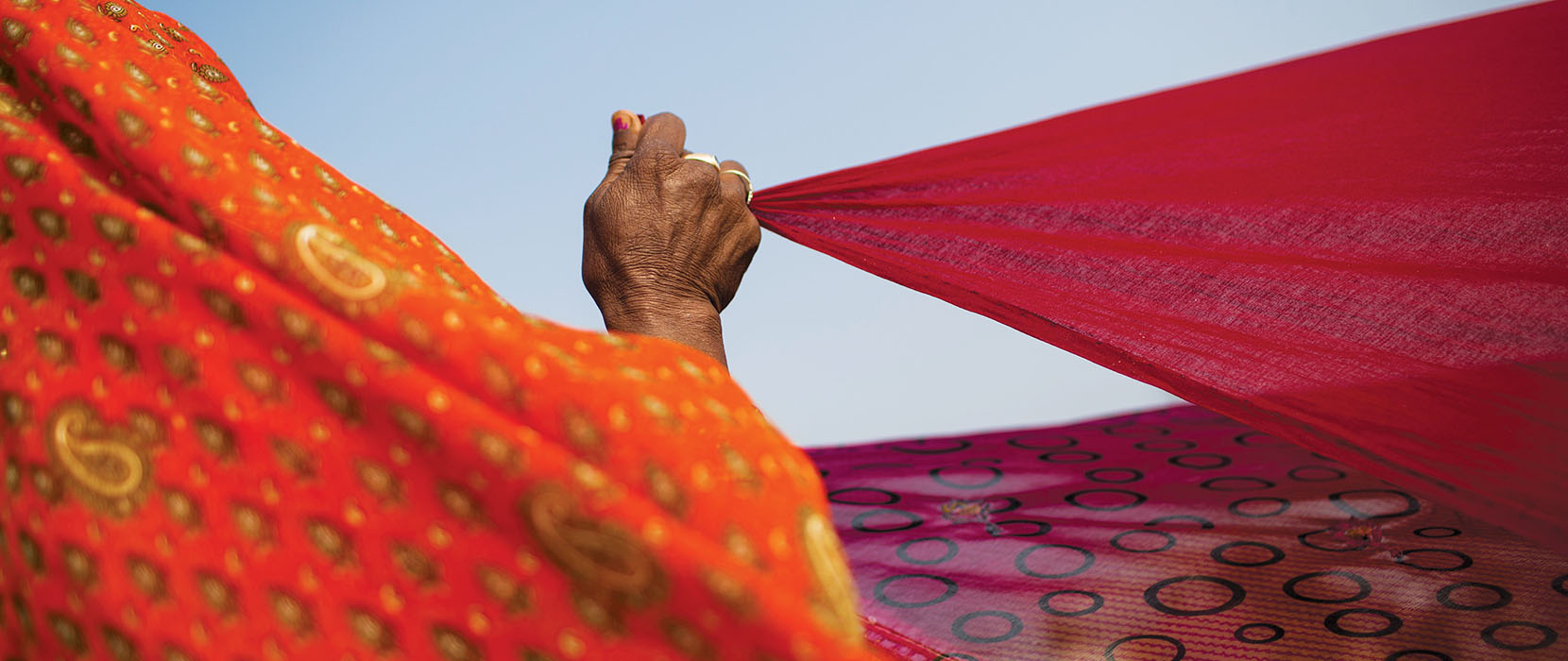 Hand holding a sari.