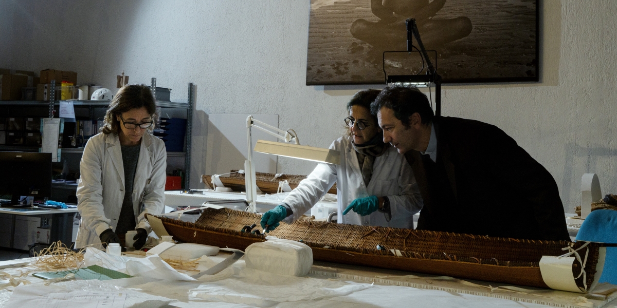 Father Nicola Mapelli and lab technicians working after hours at the conservation laboratory in the Anima Mundi gallery examine artwork currently being conserved..