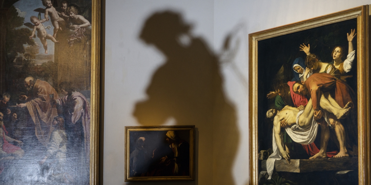 On a wall in the Pinacoteca, the picture gallery, Caravaggio’s Deposition and the shadow of a Bernini angel.