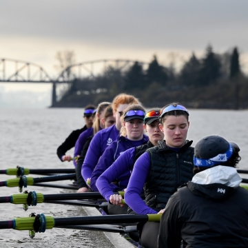 Rowers sit at the ready in an 8-person boat