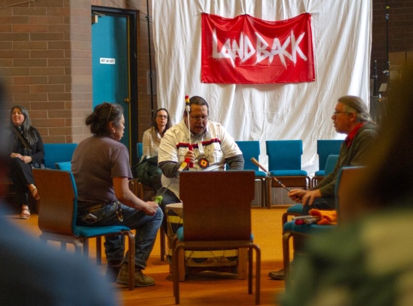 People gathered in a room during a community meeting