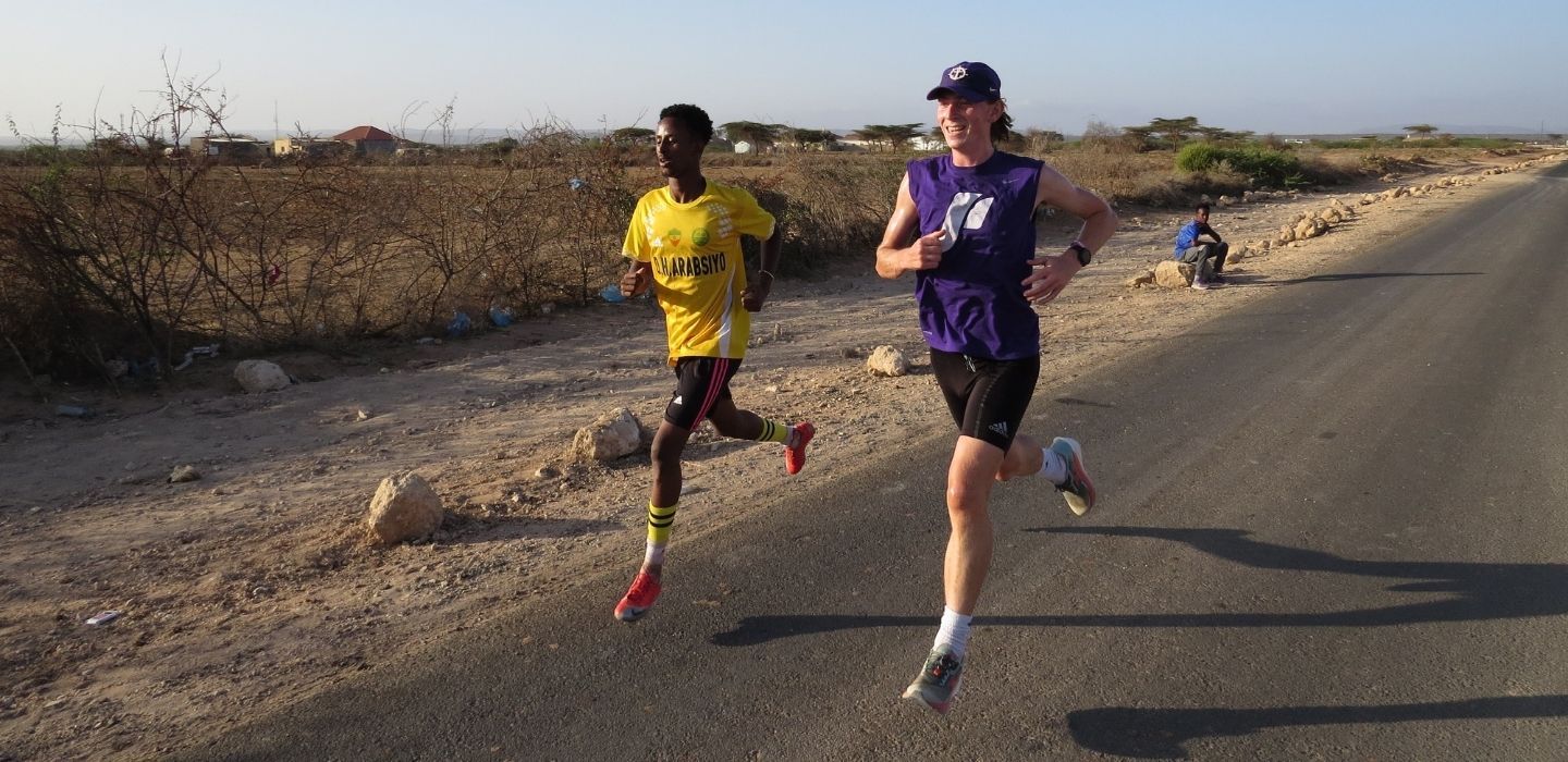 Leo Donlea running with a student in Somalia