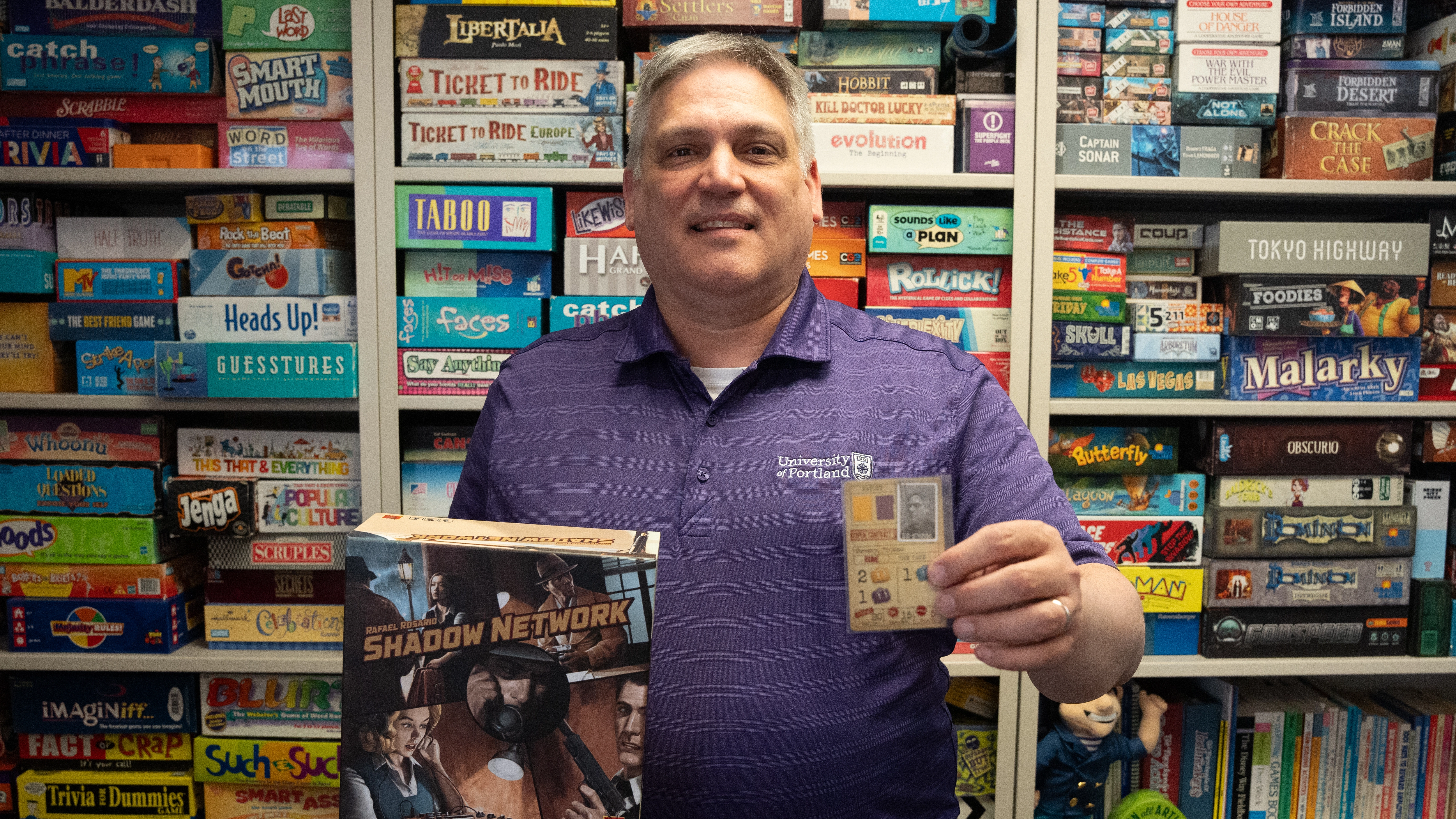 Jeromy Koffler holding two of his favorite board games