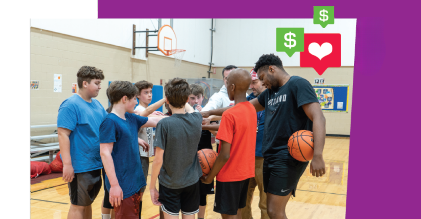 Basketball player Chika Nduka (far right) huddles up with students at the basketball clinic.