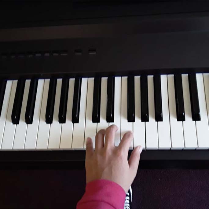 A student playing the piano.