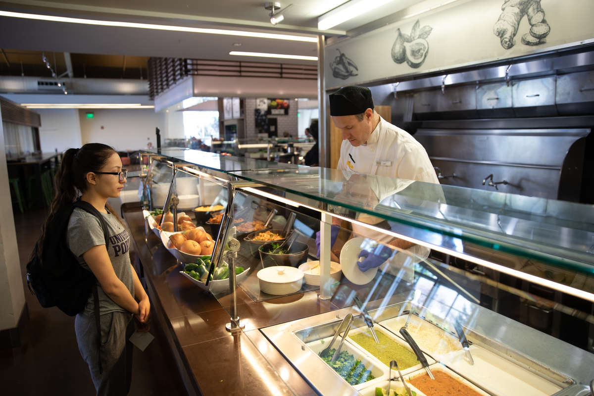 student receiving food in the commons