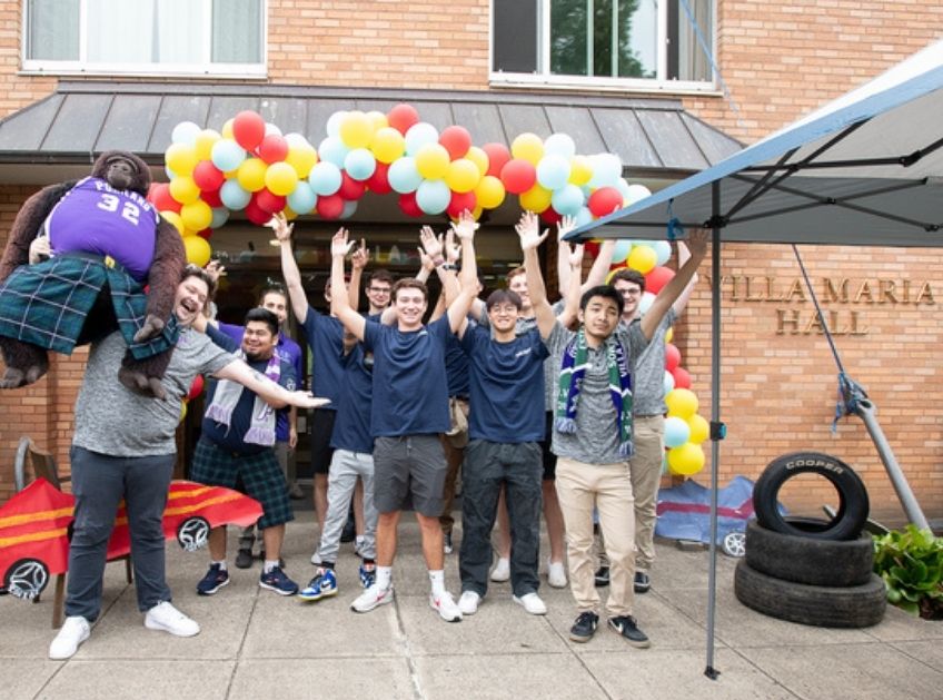 Students celebrate outside the dorm on move-in day