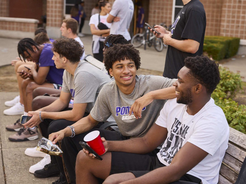 Students conversing outside of a residence hall