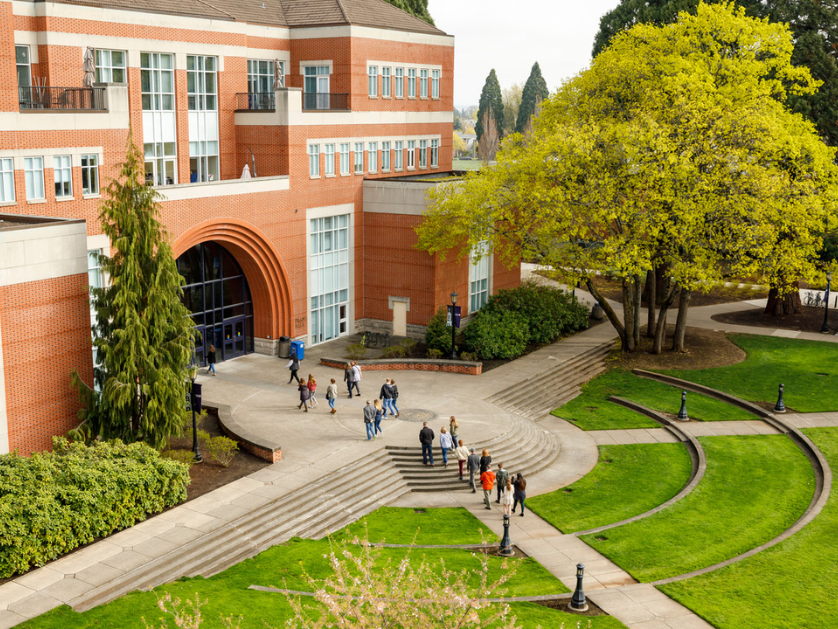 An aerial images of students walking into a campus building