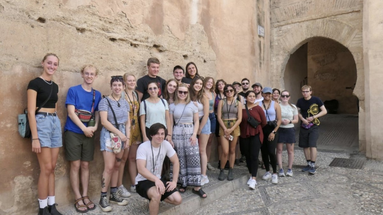 A group of study abroad students at an historic site